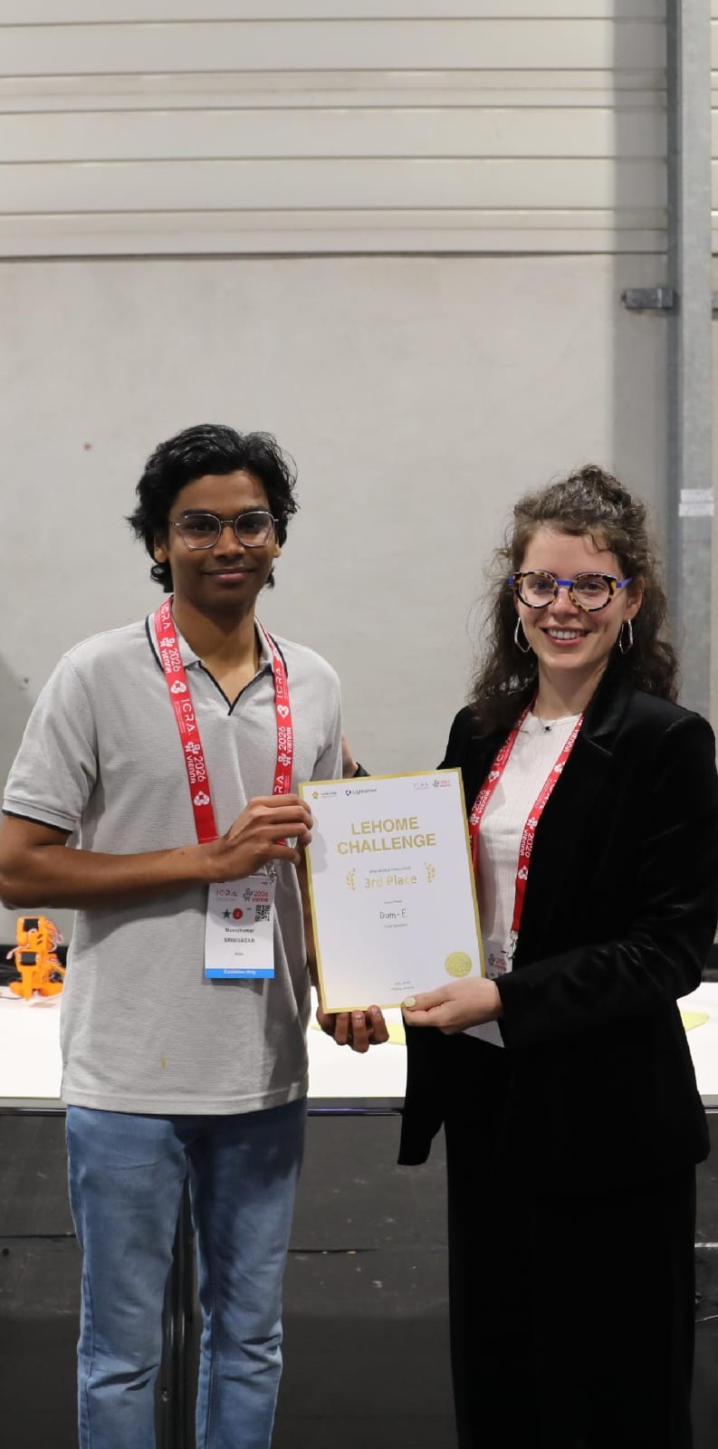 Manojkumar Srinivasan receiving the LeHome Challenge third-place certificate with Alberta Longhini.
